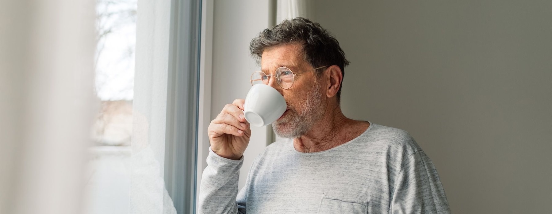 a man drinking from a cup