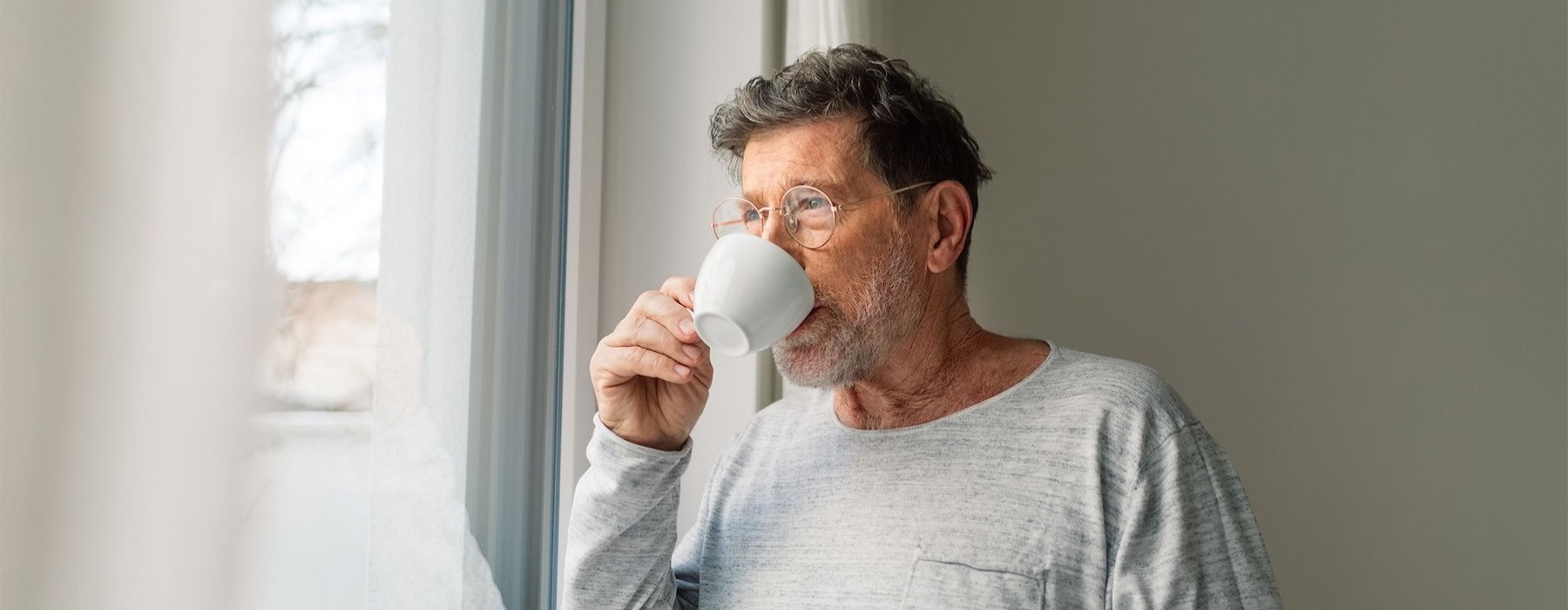 a man drinking from a cup