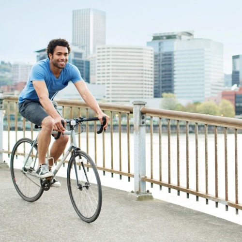 a person riding a bicycle on a bridge